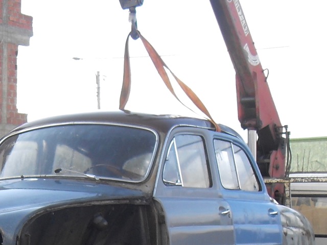 car on truck with crane